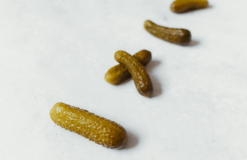 pickled cucumbers on white surface